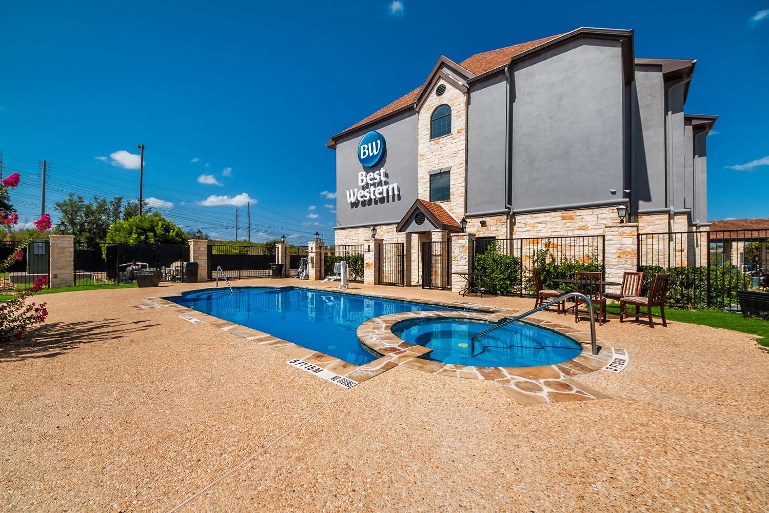 Outdoor pool area at Best hotels in San Antonio TX with lounge seating and clear blue sky
